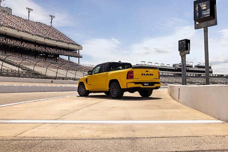 2027 Ram 1500 Rumble Bee rear three-quarter showing the bed and tailgate.