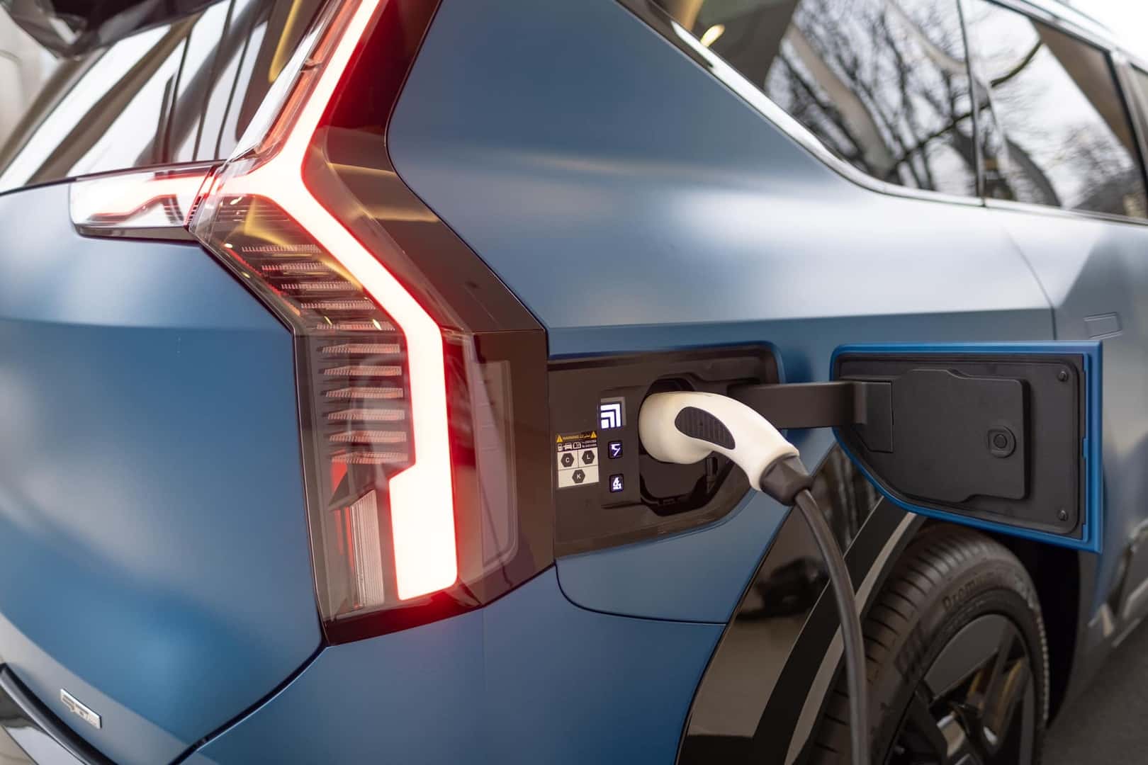 refueling gun Charger, Kia taillights close-up, electric Kia EV9 GT-Line, electric vehicle charging station