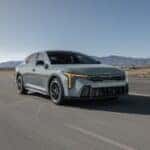 2025 Kia K4 driving down an arid road