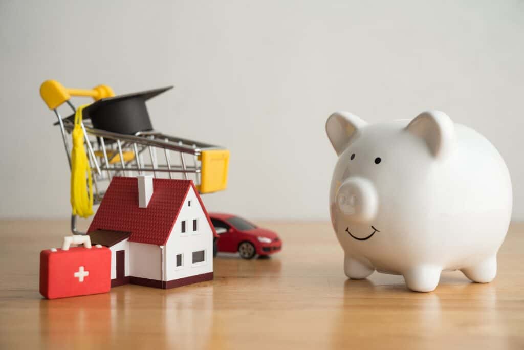Piggy bank looking at many expense (mortgage loan, education, car, medical, etc). Savings management for vary expense in crisis, home finance, household debt, saving planning for future wealth concept