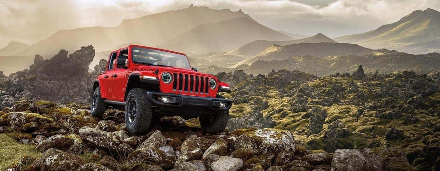 Red Jeep on rocks