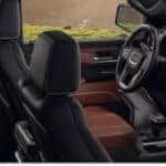 Interior view of a 2026 GMC Sierra 1500 showing brown leather seats, digital infotainment screen, and dashboard.