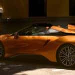 BMW I sitting under tree shade in city