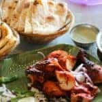 Indian Food & Naan Bread on plates at a table in Fort Worth, TX
