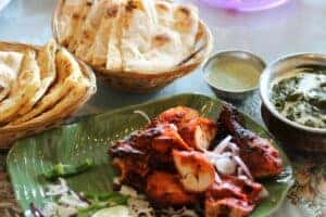 Indian Food & Naan Bread on plates at a table in Fort Worth, TX