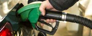 Person putting premium fuel in their Mazda vehicle at a gas station