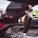 Man changing the oil on a Mazda