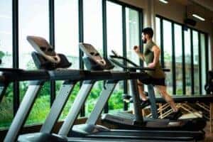 Man running on treadmill in gym