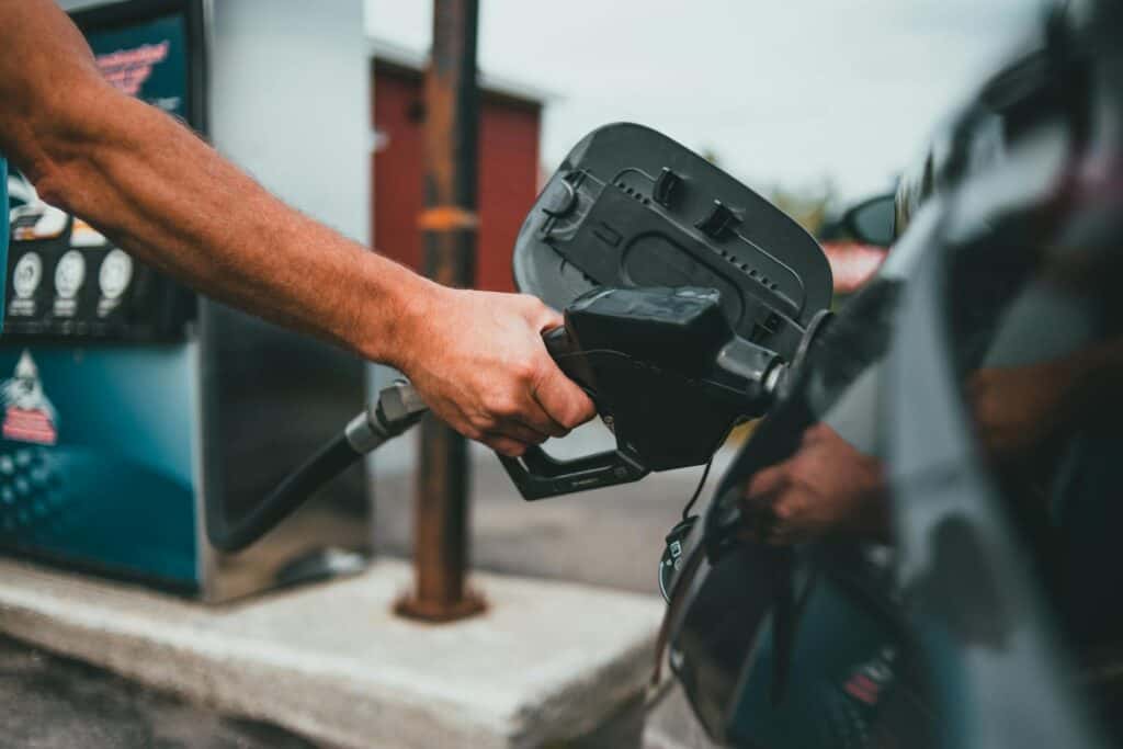 Person Putting Gasoline in a Vehicle