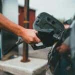 Person Putting Gasoline in a Vehicle