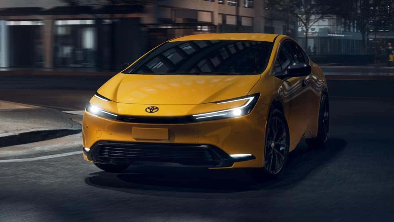 Yellow Toyota Prius driving at night