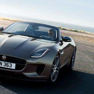2020-Jaguar-F-TYPE-R-Dynamic-in-Silicon-Silver-driving-around-corner