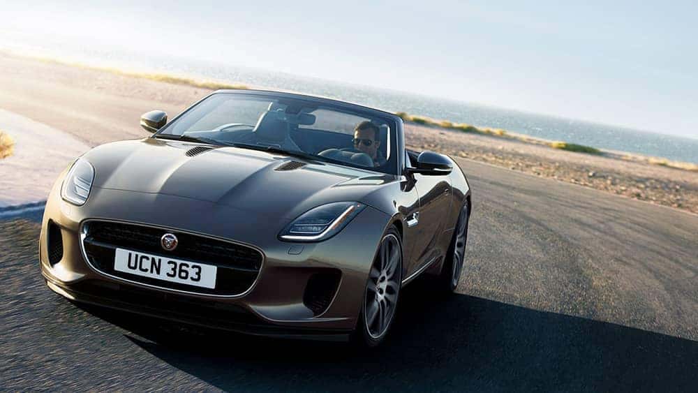 2020-Jaguar-F-TYPE-R-Dynamic-in-Silicon-Silver-driving-around-corner