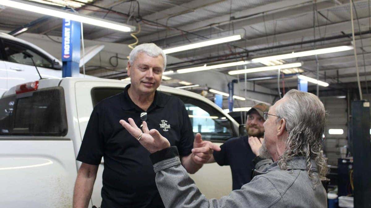 Service advisor talking with a customer in the Jim Taylor Buick GMC service department in Monroe, Louisiana