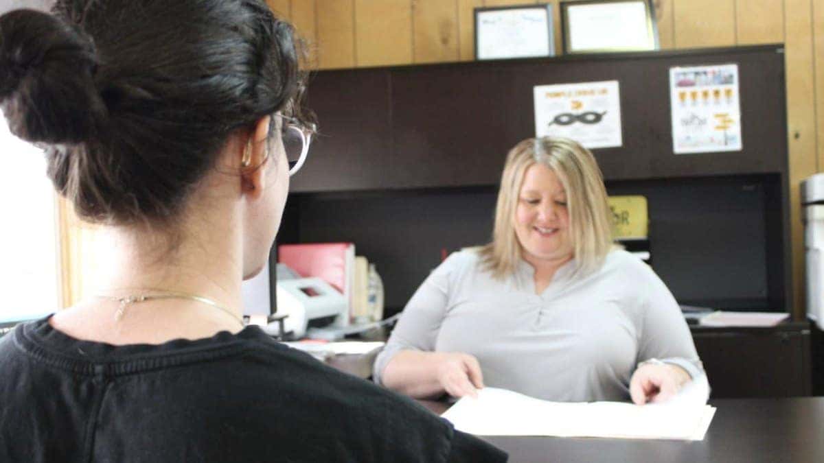 Reviewing used-vehicle warranty paperwork with a customer at Jim Taylor Buick GMC in Monroe, LA