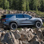 2026 Chevrolet Traverse driving over rocky terrain in the mountains