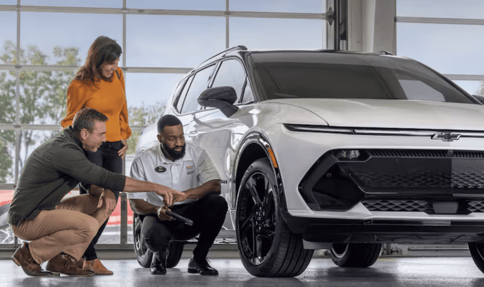Chevrolet service advisor explaining genuine parts to customers in the service bay