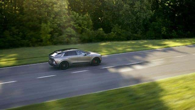 a Cadillac LYRIQ-V on a rural road