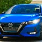 Nissan Ellicott 2022 Nissan Sentra beautiful blue car driving through greenery.
