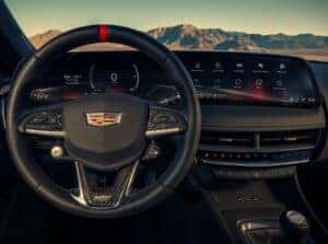 Interior view of the 2025 Cadillac CT5-V showcasing the high-definition digital display, featuring performance data, navigation, and driver-focused controls in a sleek, modern layout.