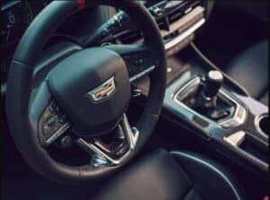 2025 Cadillac CT4-V performance steering wheel featuring a sporty, ergonomic design with available carbon fiber accents and integrated controls for an enhanced driving experience.
