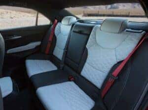 2025 Cadillac CT4-V interior featuring bold Torch Red seatbelts that enhance the performance-inspired cabin design.