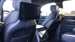 2026 Cadillac Escalade IQ interior showing the available Executive Second Row with extra legroom, premium audio, and advanced tech and charging features at Patrick Cadillac.