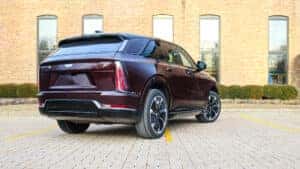 2026 Cadillac Escalade IQ demonstrating 4-Wheel Steer technology, showing rear wheels turning in coordination with the front for enhanced maneuverability and stability at Patrick Cadillac.