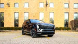 Exterior view of the 2026 Cadillac Escalade IQ highlighting its sleek all-electric design, illuminated front grille, bold lines, and modern LED lighting at Patrick Cadillac.