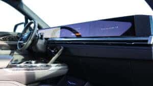 2026 Cadillac Escalade IQ interior featuring the 55-inch curved pillar-to-pillar LED display showcasing infotainment, navigation, and essential applications at Patrick Cadillac.