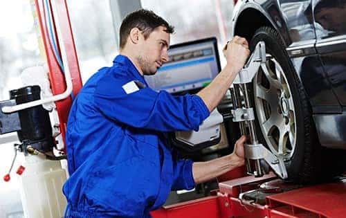 technician aligning tires