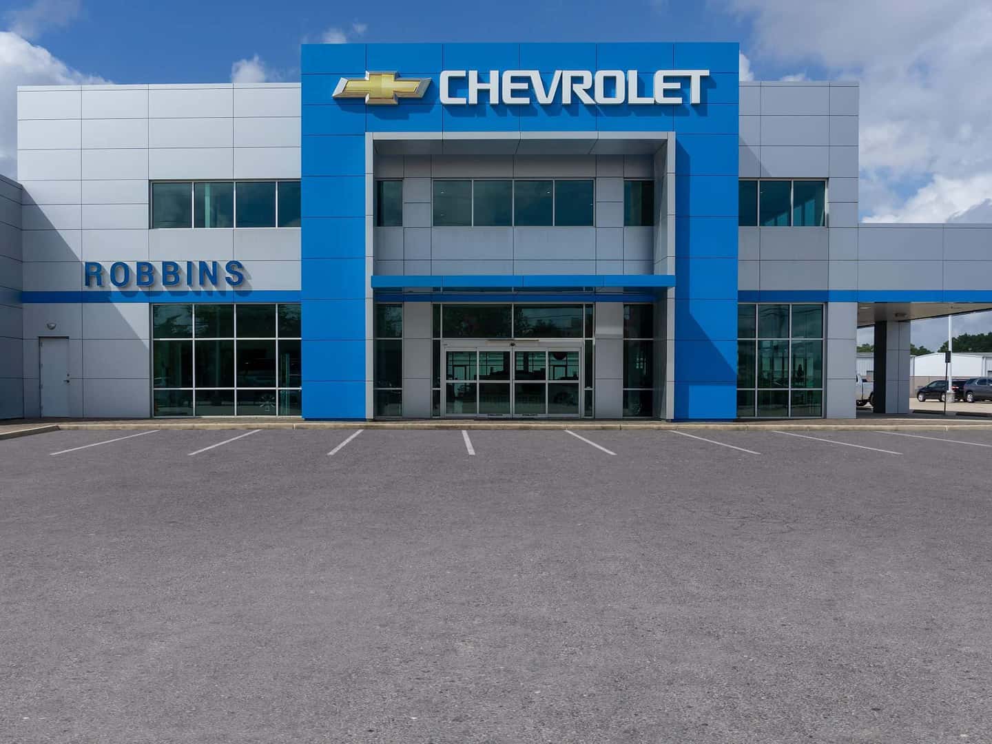 An exterior shot of a Chevrolet dealership at night.