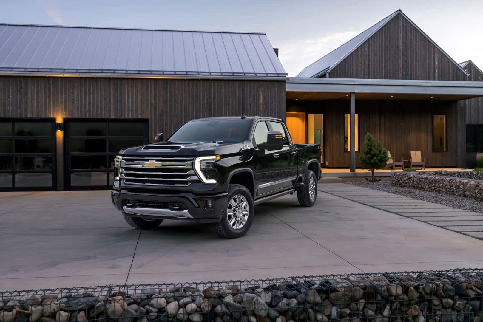 The Spectacular Exterior Of The Fantastic 2024 Chevy Silverado 2500HD, Parked Outside A Handsome Home