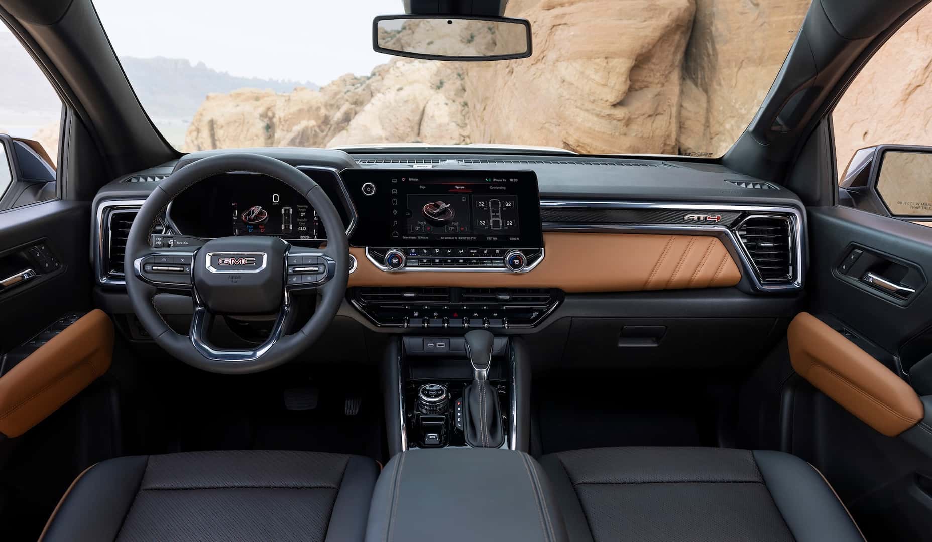 Interior view of GMC Canyon AT4 with off-road pitch and roll screen on the cluster.