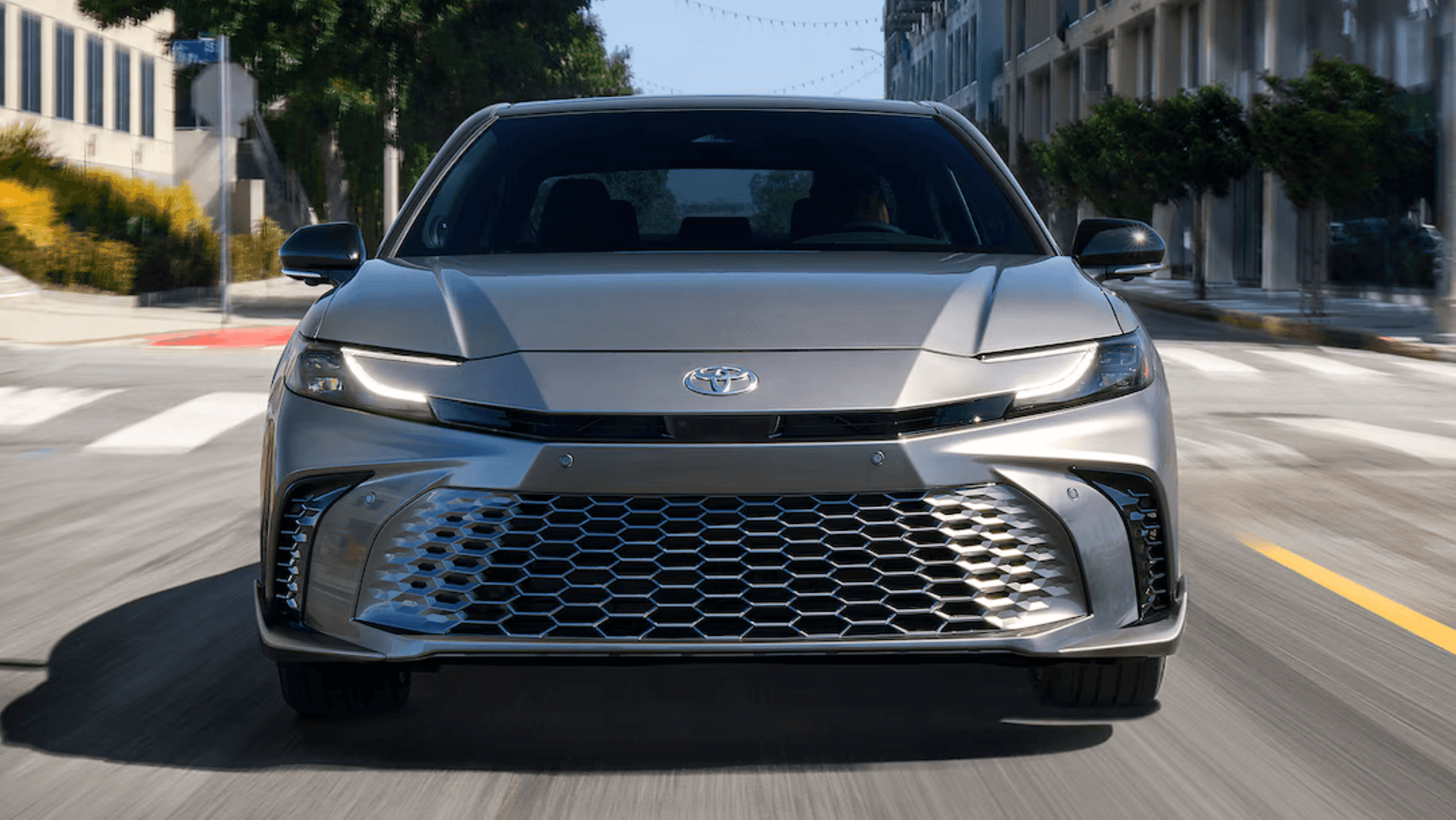 The Favorite 2025 Toyota Camry Hybrid, Cruising City Streets With Bright Headlights