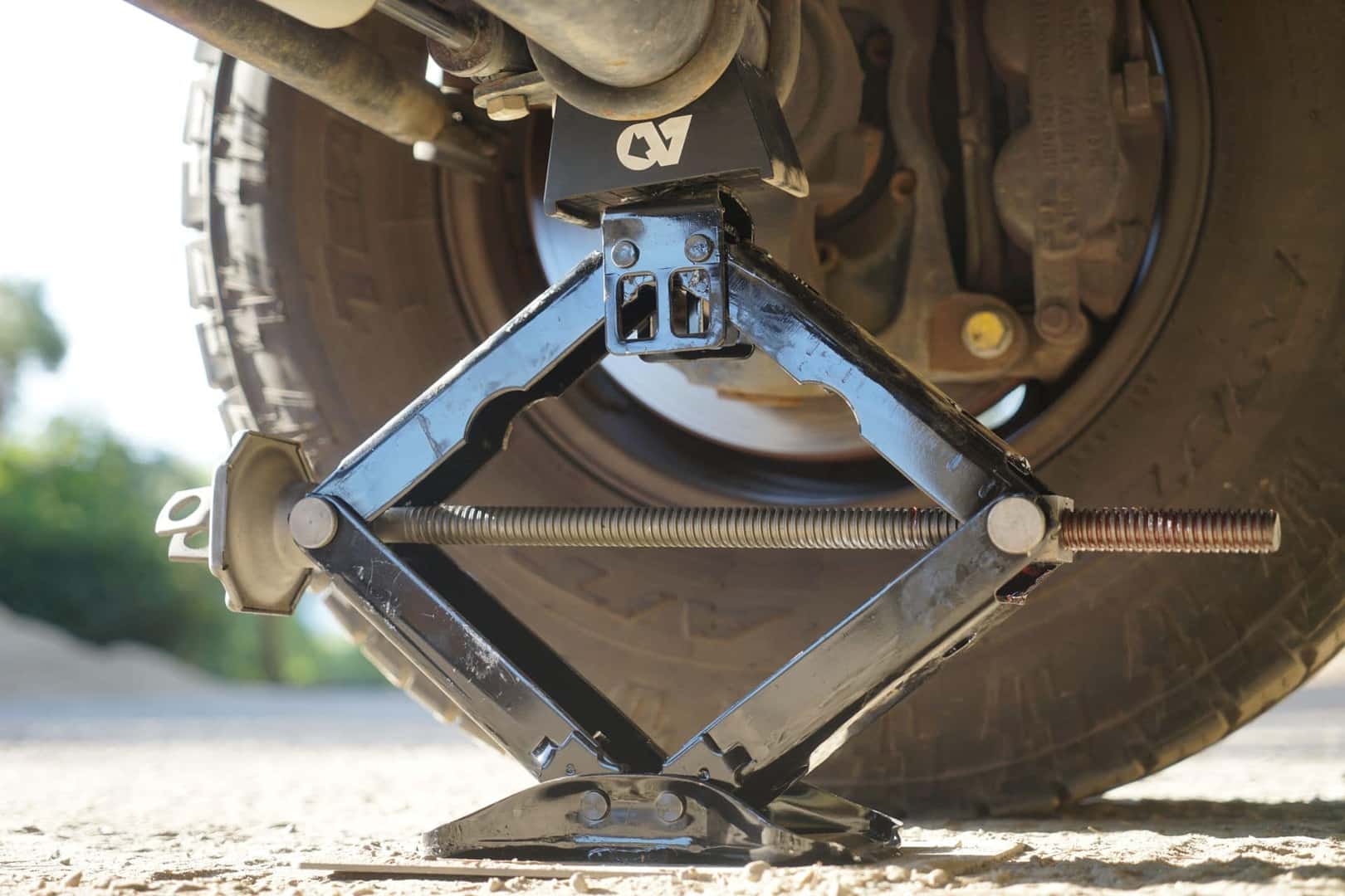 A Heavy Duty Scissor Jack Being Used On A Car Wheel
