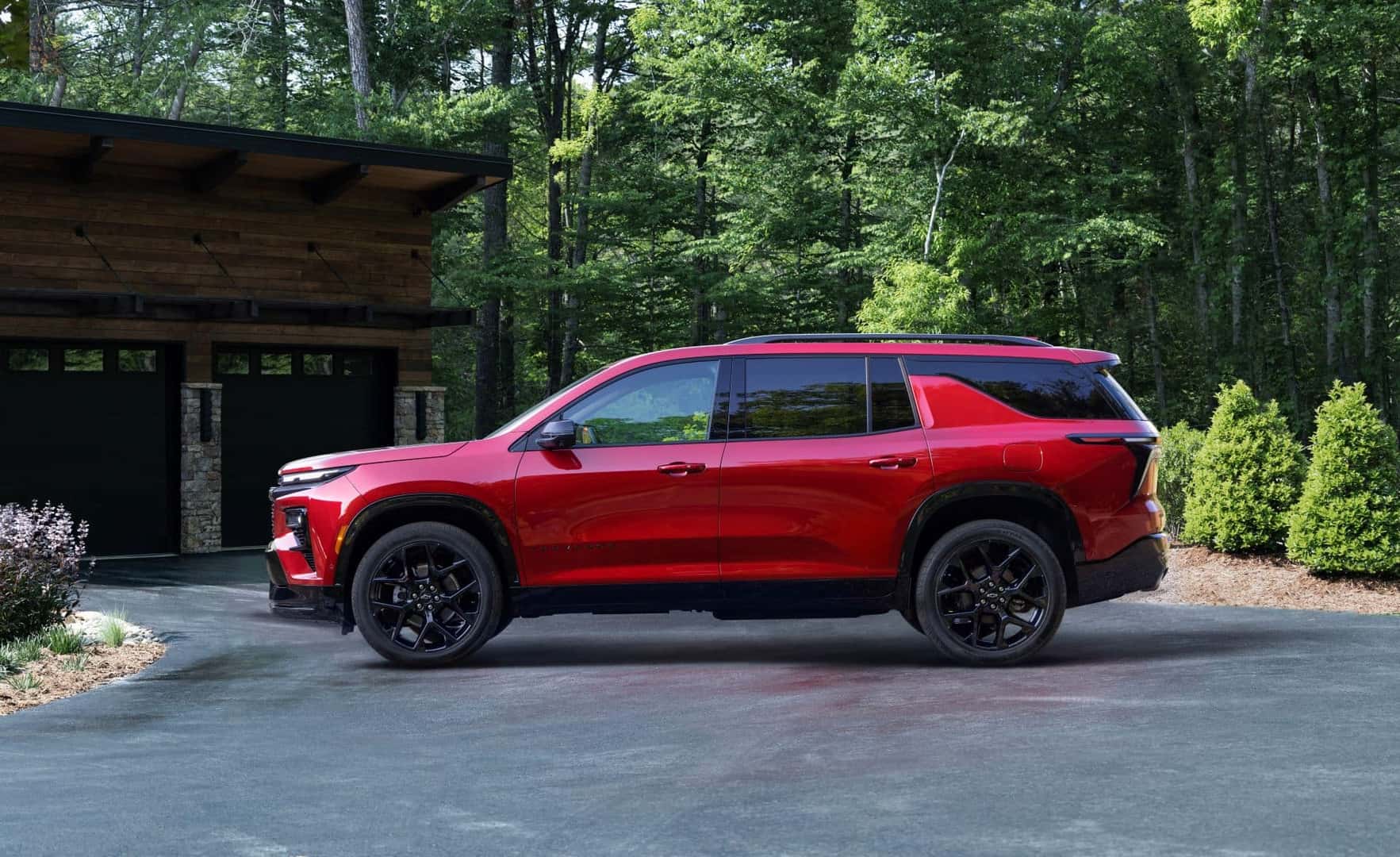 The Stylish Side Profile OF The 2024 Chevrolet Traverse, Parked Outside The Family Cabin