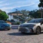 The Stellar Lineup Of The Inspiring And Fuel-Efficient 2025 Toyota Camry, Parked In Front Of A Plaza With A Gorgeous Gazebo