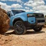 The Off-Roading Beast: The 2025 Toyota Land Cruiser Peeking Behind A Rock