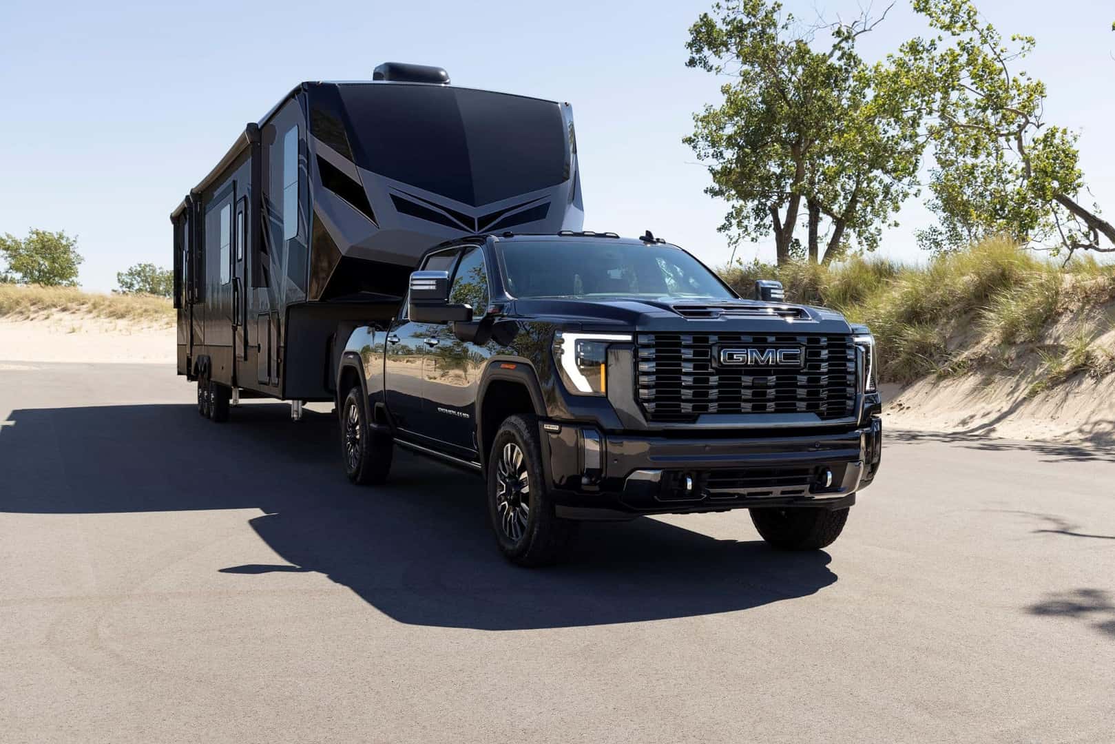 The Herculean 2024 GMC Sierra 2500HD, Towing A Long Camper And Driving On The Road