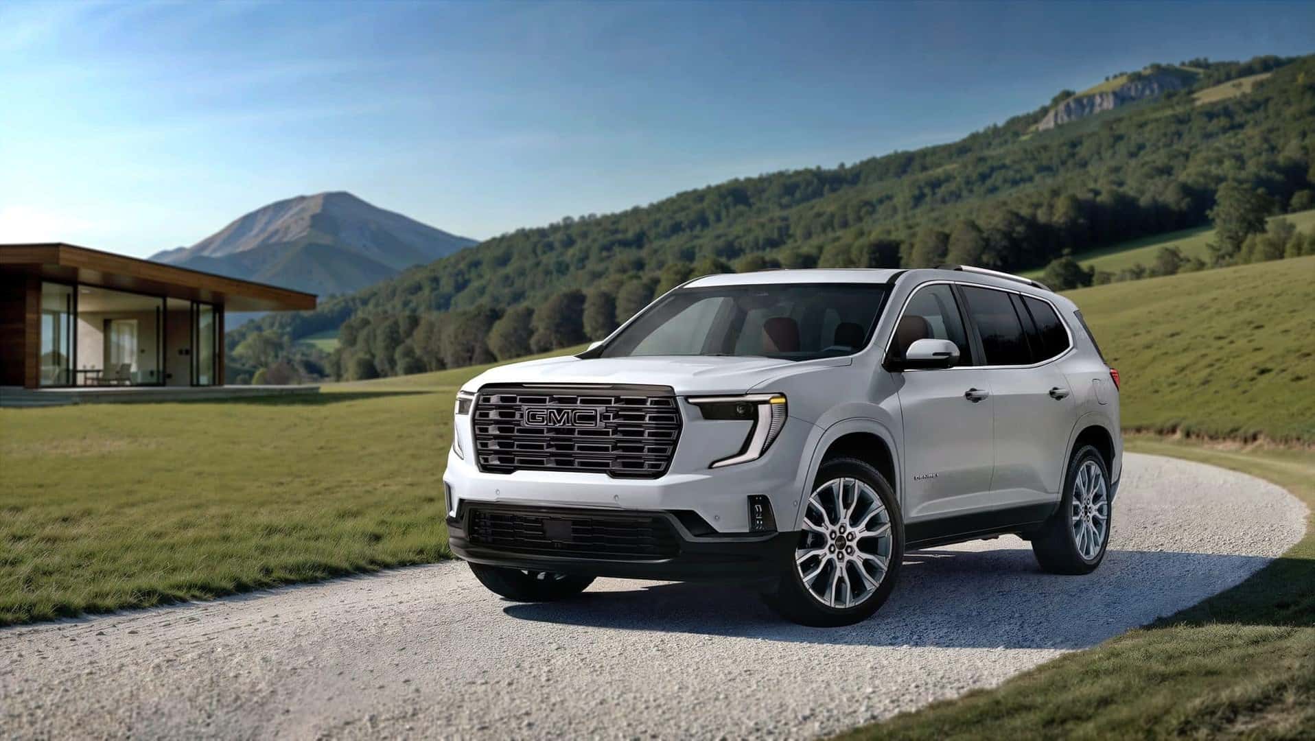 The Pearl White Exterior Of The 2026 GMC Acadia Denali Ultimate, Driving Out Of A Long, Twisting Driveway