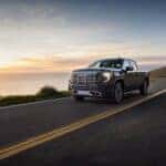 The Agile 2026 GMC Sierra Denali Driving On The Highway During A Gorgeous Sunset