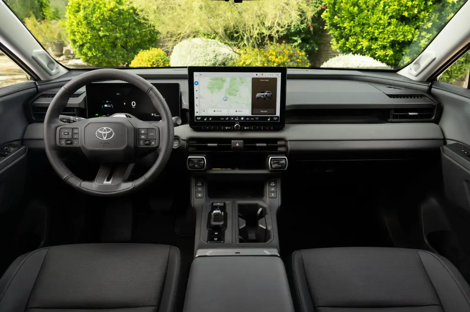 2026 Toyota Rav4 interior of the front cabin looking towards greenery