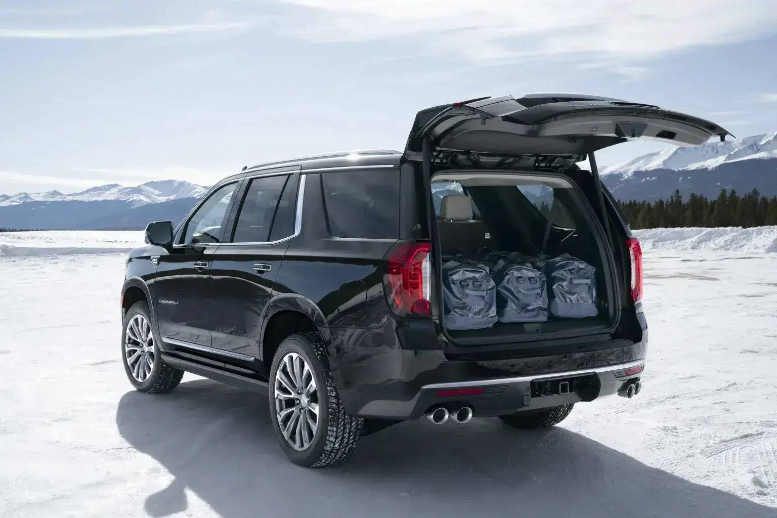 GMC Yukon Denali cargo space parked off road in the snow