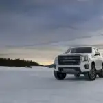 White GMC Yukon Denali cargo space parked off road in the snow