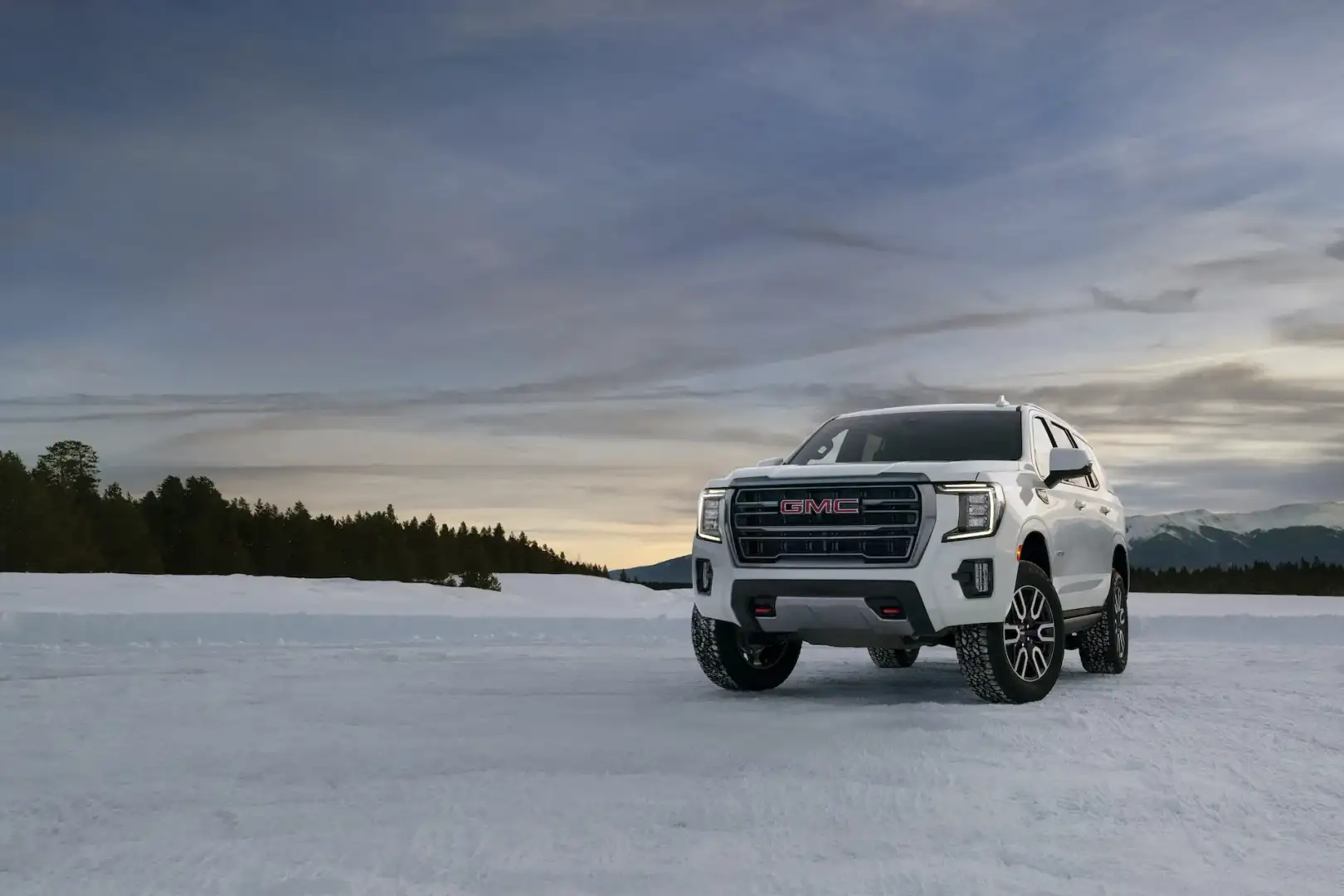 White GMC Yukon Denali cargo space parked off road in the snow