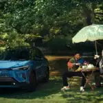 2026 Toyota Corolla Cross parked under a tree by a picnic table