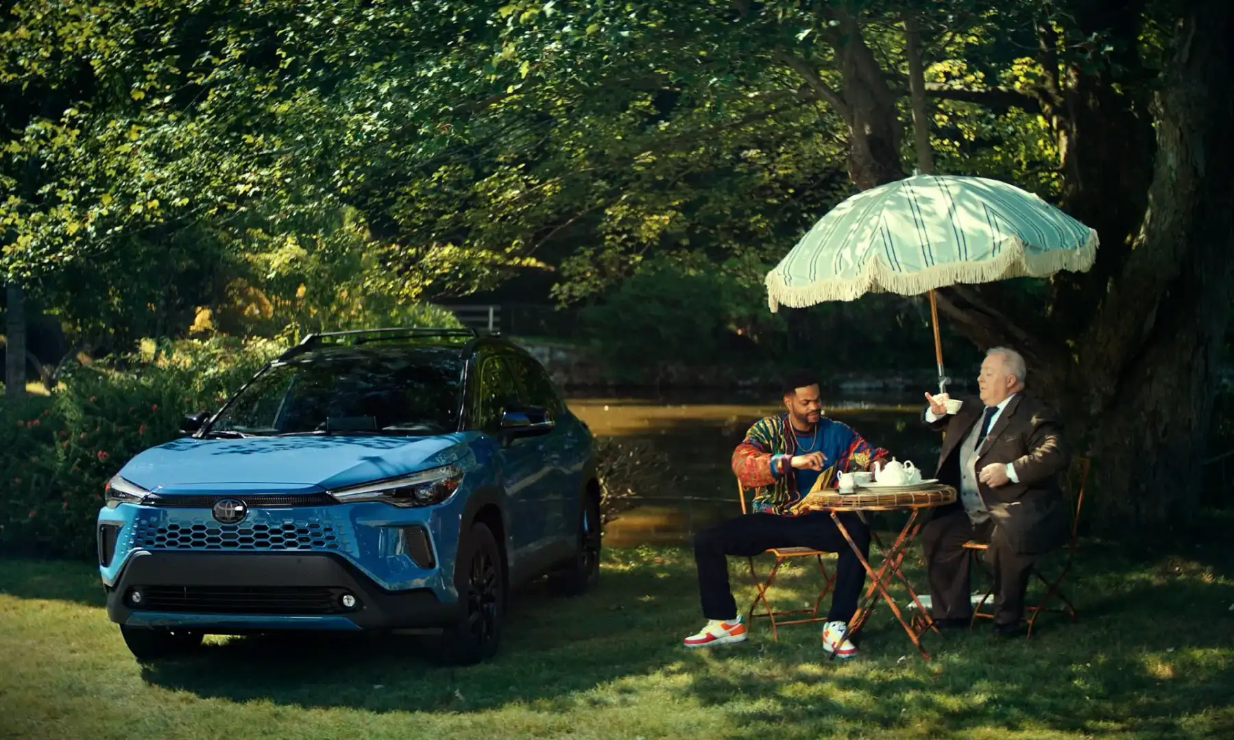 2026 Toyota Corolla Cross parked under a tree by a picnic table