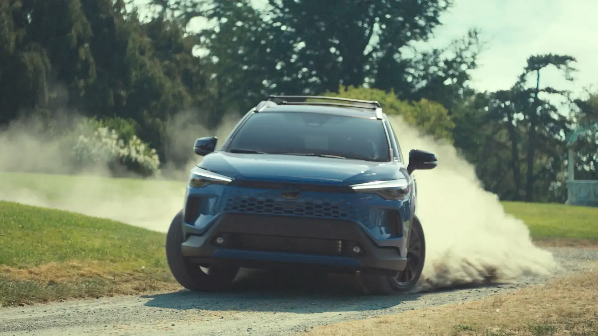 2026 Toyota Corolla Cross driving on a dirt road kicking up dust 