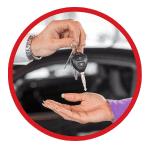 circle-cropped image of a hand giving over keys.
